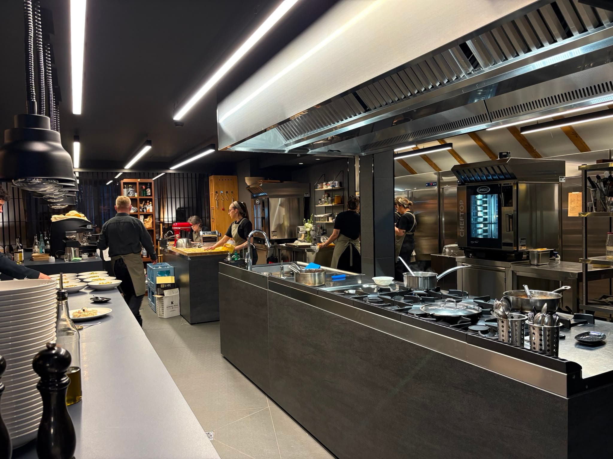 A restaurant team working together in a professional service kitchen